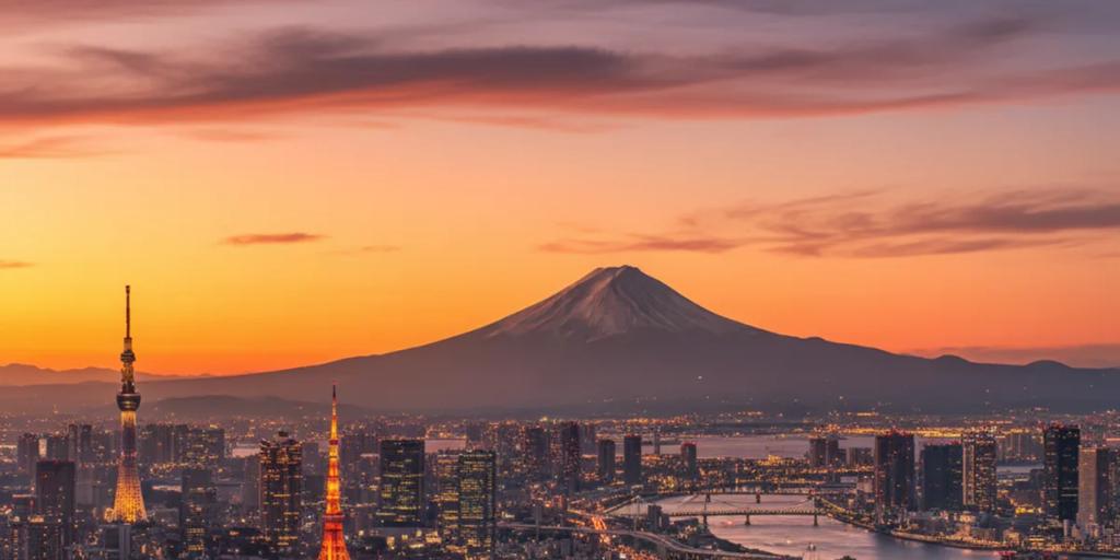 Ufukta yükselen Fuji Dağı ile alacakaranlıkta Tokyo silüeti